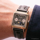 Fossil moonphase watch with black leather strap on wrist