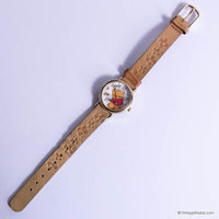 Wristwatch with a brown strap and cartoon character face on a white background