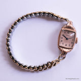 Vintage watch with a decorative chain strap on a white background