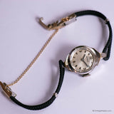 Wristwatch with black strap and gold chain on a white background
