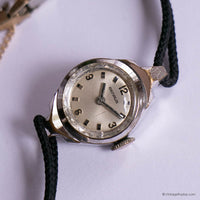 Vintage wristwatch with a black strap on a white background