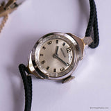 Vintage wristwatch with a black strap on a white background