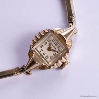 Vintage gold watch with a Bulova face on a white background