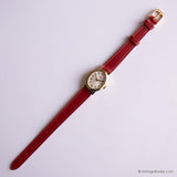 Vintage Gold-Ton Timex Damen Uhr mit ovaler Gehäuse und rotem Gurt
