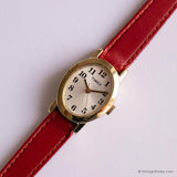 Tone d'or vintage Timex Dames montre avec boîtier ovale et sangle rouge