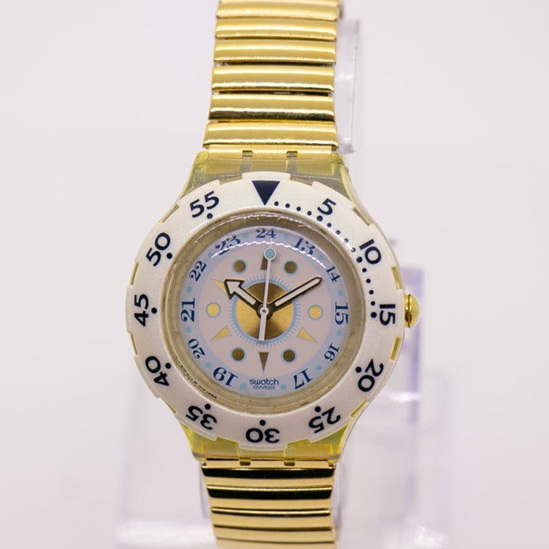 Swatch Cream and Gold Watch with Round Face and Textured Band. Water resistant Round Face Stretch Watch in Gold | Altar main image 2